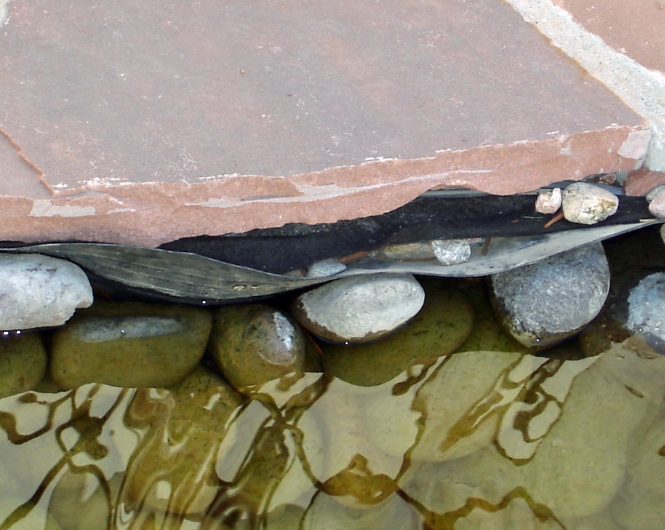 No matter the cause, nobody is particularly happy when a once-concealed pond liner pops into view.  And it's sad, writes Dave Garton, because these exposures can usually be avoided if the installer works wisely with the liner and takes the time to select and place rocks with care. 