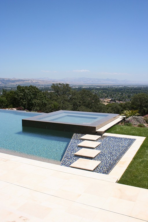 Inspired by the work of great architects, watershaper Paul Benedetti has created a masterpiece of his own in the form of a pool/spa composition that now graces a spectacular setting in Santa Cruz Mountains of California. Using multiple water levels, reflective surfaces and water-in-transit effects, the design delivers straight-ahead contemporary aesthetics while encompassing a sublimely complicated set of geometric and hydraulic relationships.
