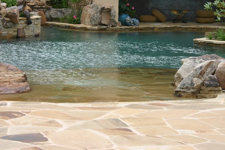 Any backyard project that encompasses tons of stone, hundreds of square feet of glass tile, a complex waterfall structure, a large bridge, an island spa and other features focused on fun, elegance and beauty is likely to be something special. In this case, it happens to be one of master watershaper David Tisherman’s most intricate achievements to date – one he guides us through in this pictorial, which captures the challenges as well as the glorious results of an enormous collaboration.