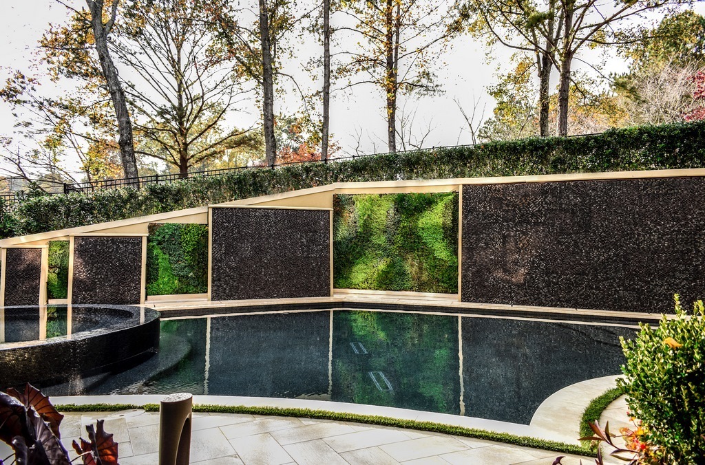 The home sits on the edge of a lovely golf course, but it's backyard definitely needed help. Completely reimagining the space, Juliet Wood inserted a pool, a spa, a cabana, a sweeping staircase and an amazing water wall to create a fully integrated resource for outdoor family fun.